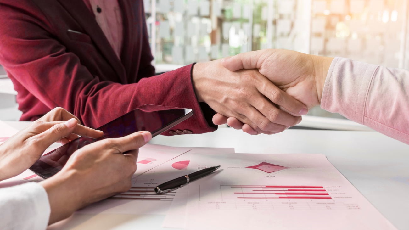 Business handshake of two men demonstrating their agreement to sign agreement or contract between their firms, companies, enterprises